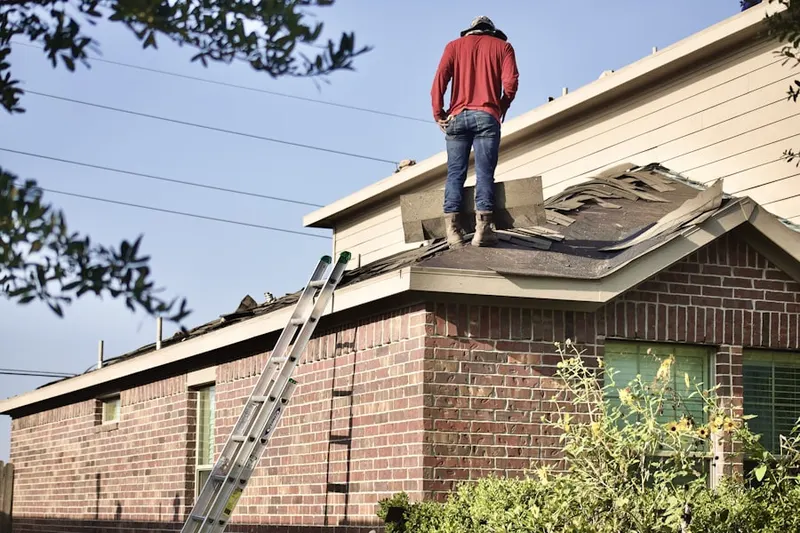Professional roofer working on a residential roof in Dugan
